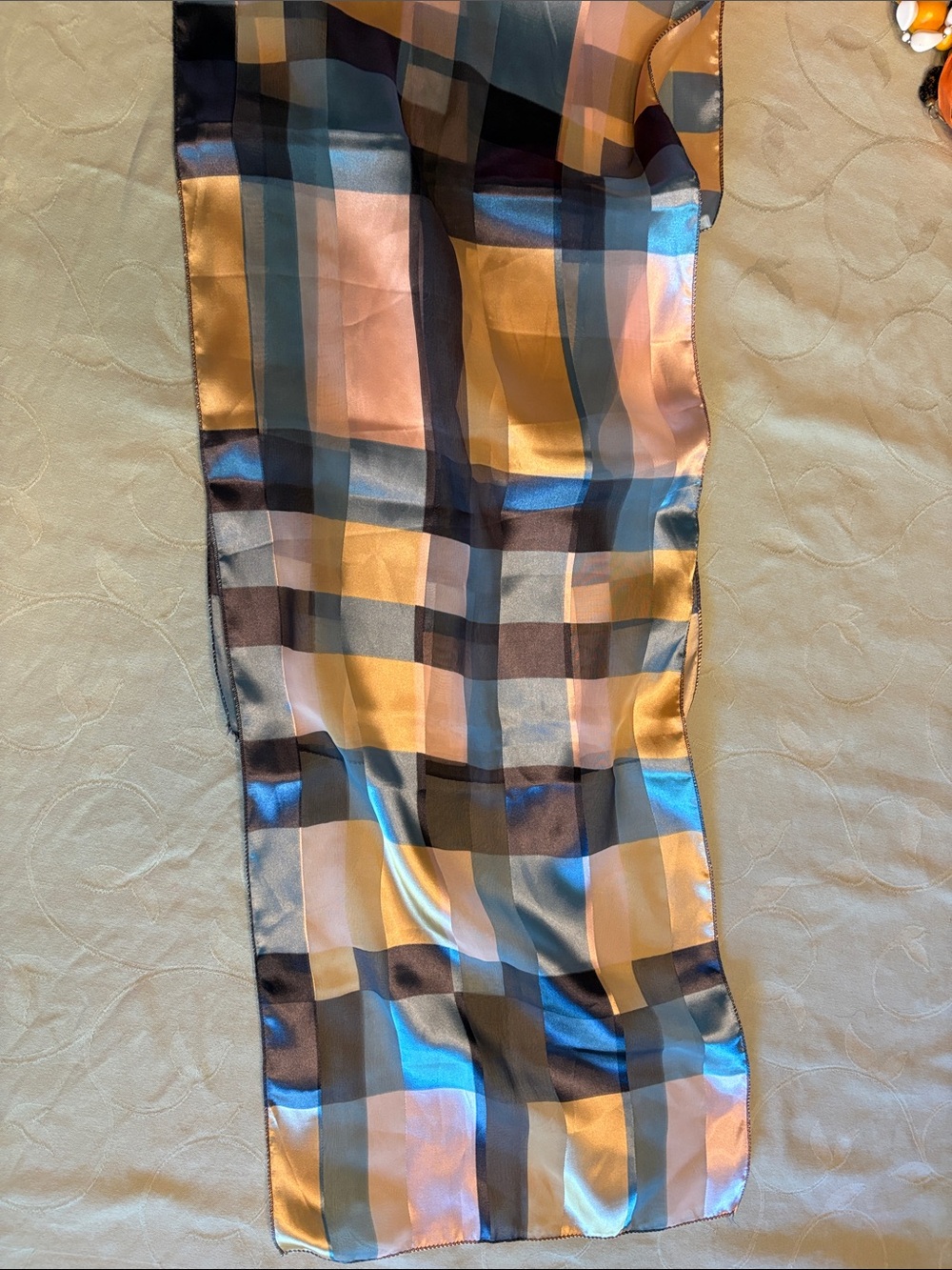 Lustrous dressy scarf with sheer sections.